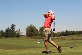 Golfer takes a swing
