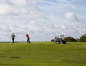 2 golfers and golf cart